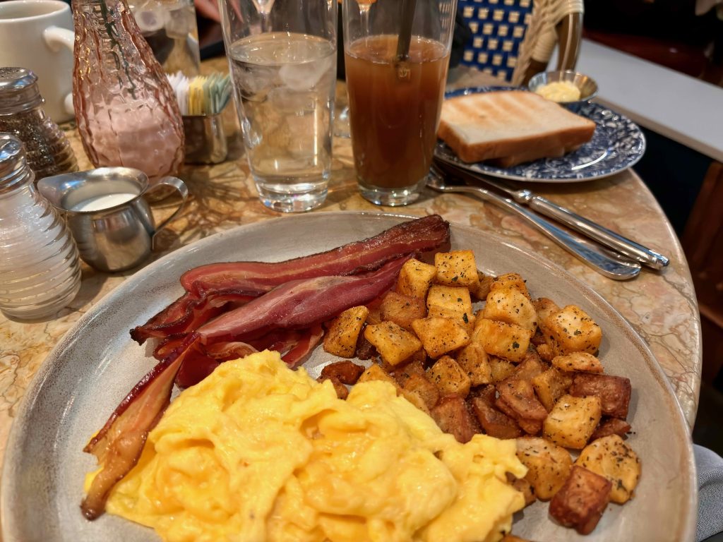 Gluten-free scrambled eggs, breakfast potatoes, and bacon